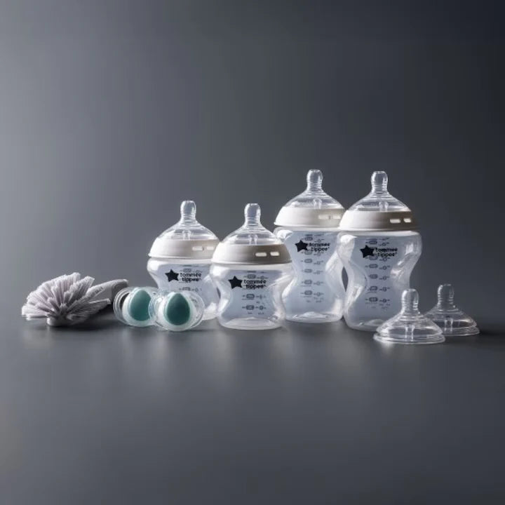 Newborn baby bottle starter set with clear bottles, teats, and cleaning brush