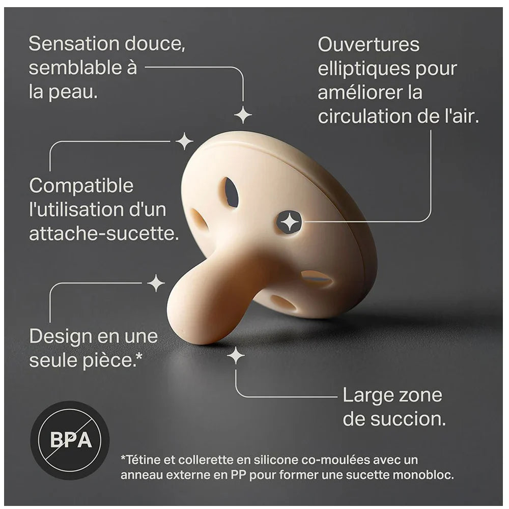 Light beige breast-like silicone pacifier with vented shield.