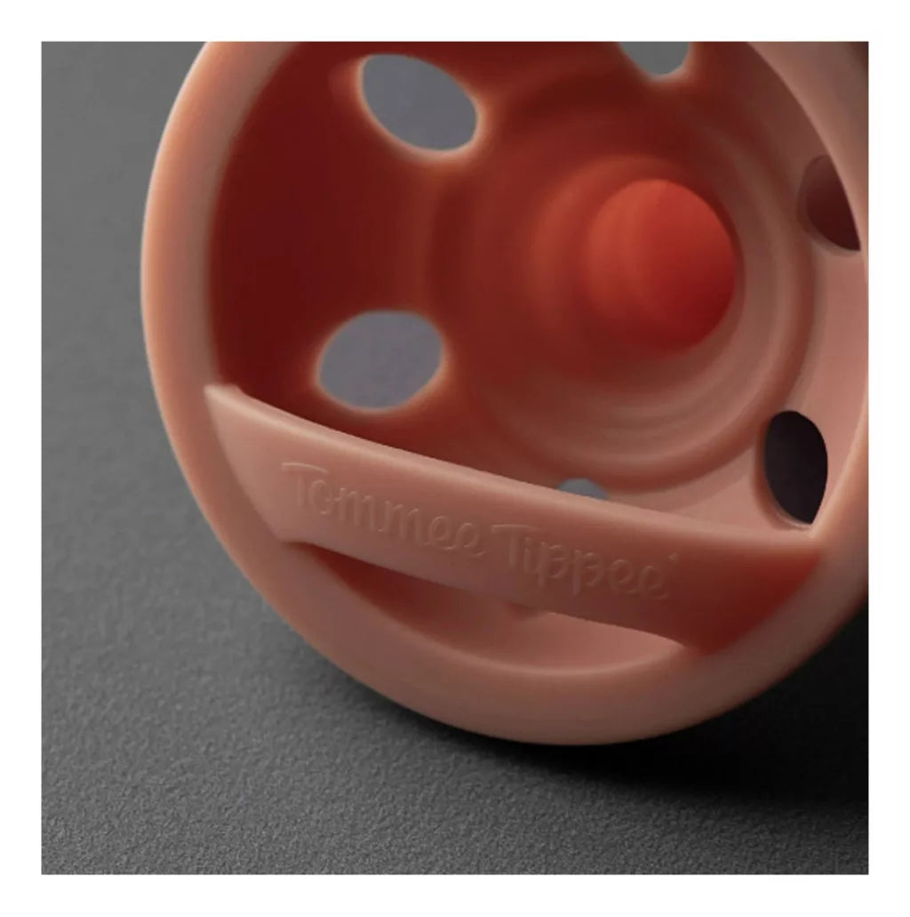 Peach pacifier with round shield and air holes for 6–18 months