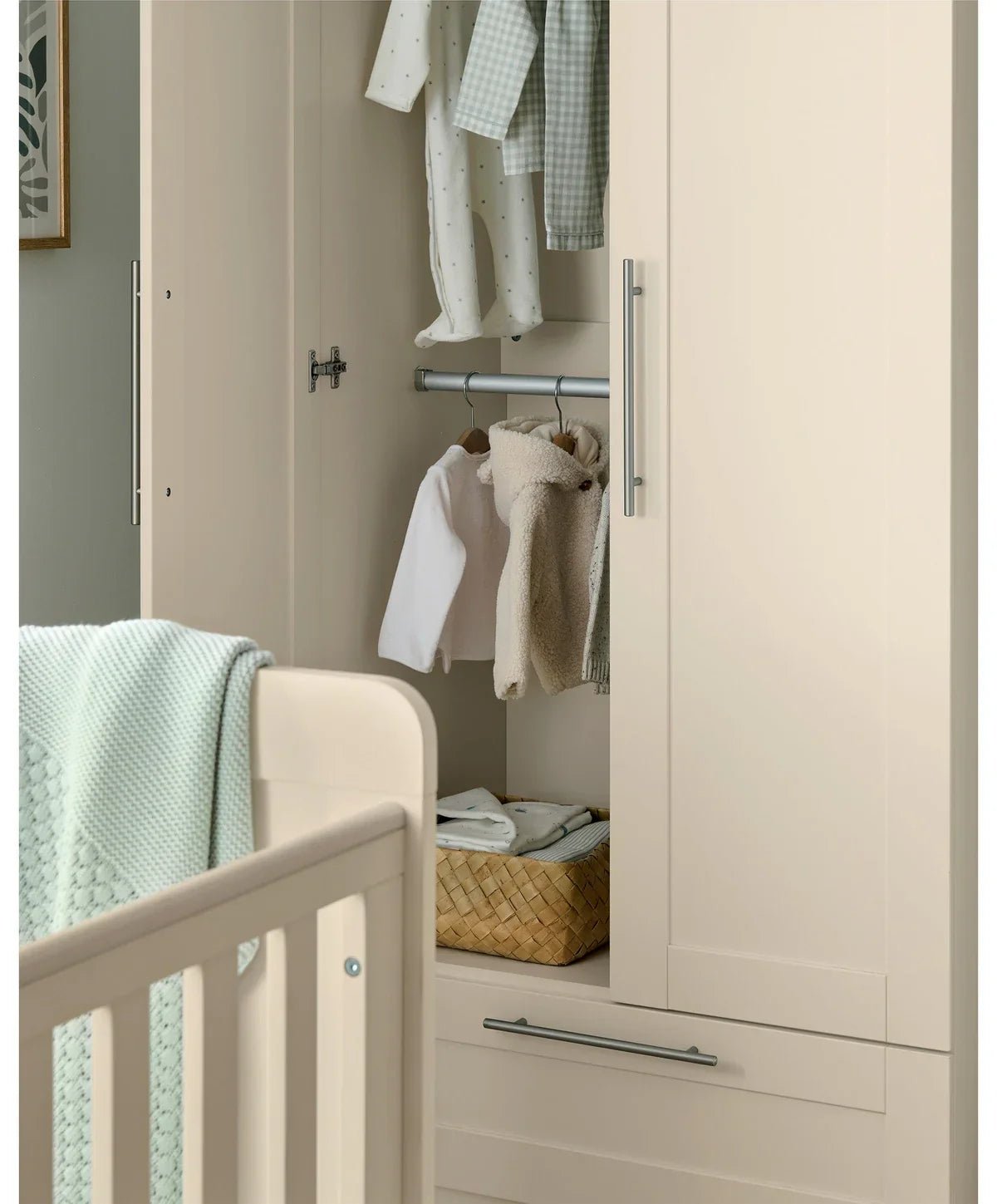 Open cream cashmere wardrobe with hanging rod, hooks, and folded clothes