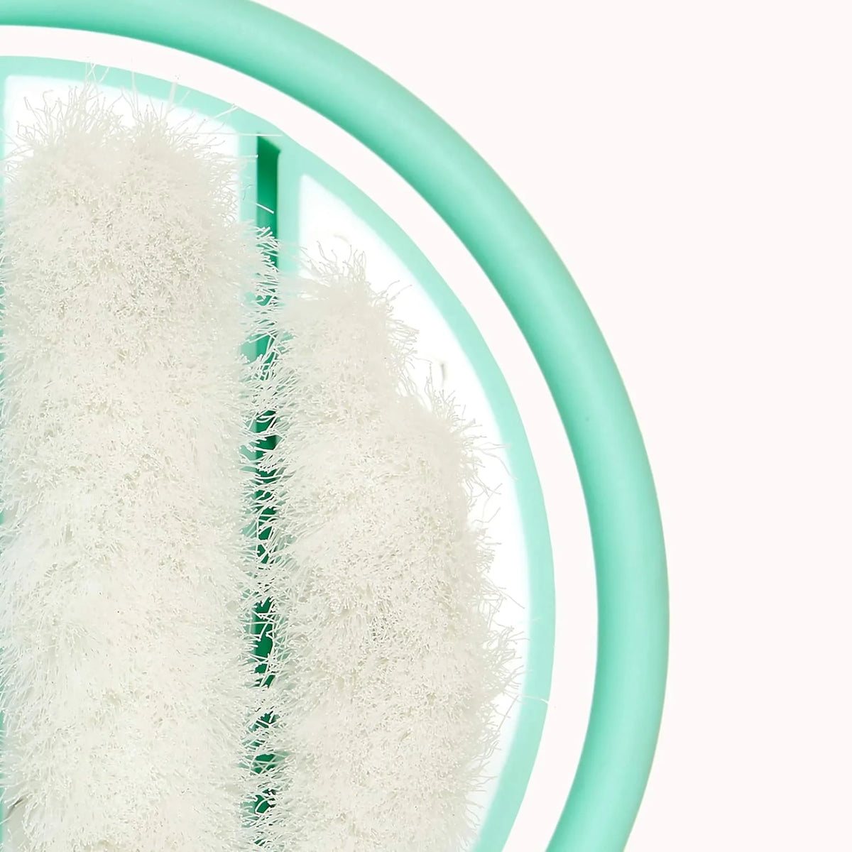 Infant head-hugging hairbrush bristles close-up on teal flexi head