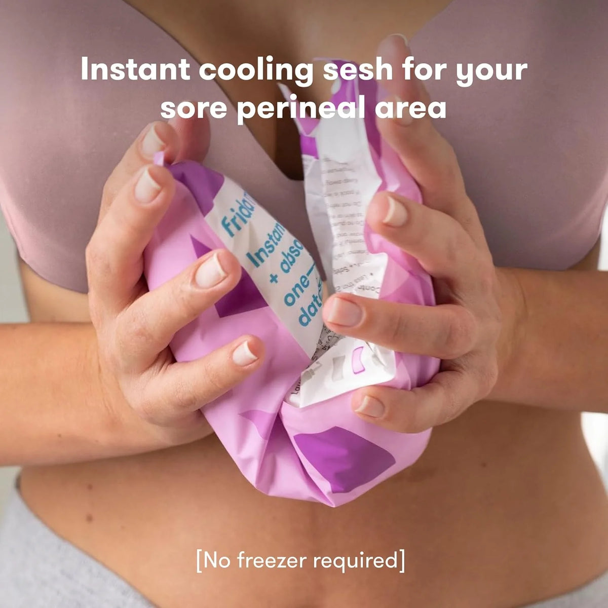 Postpartum ice maxi pad in hands, white absorbent pad with purple wrap