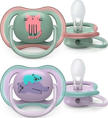 Two pacifiers with cat and dog animal designs, mint and lavender shields