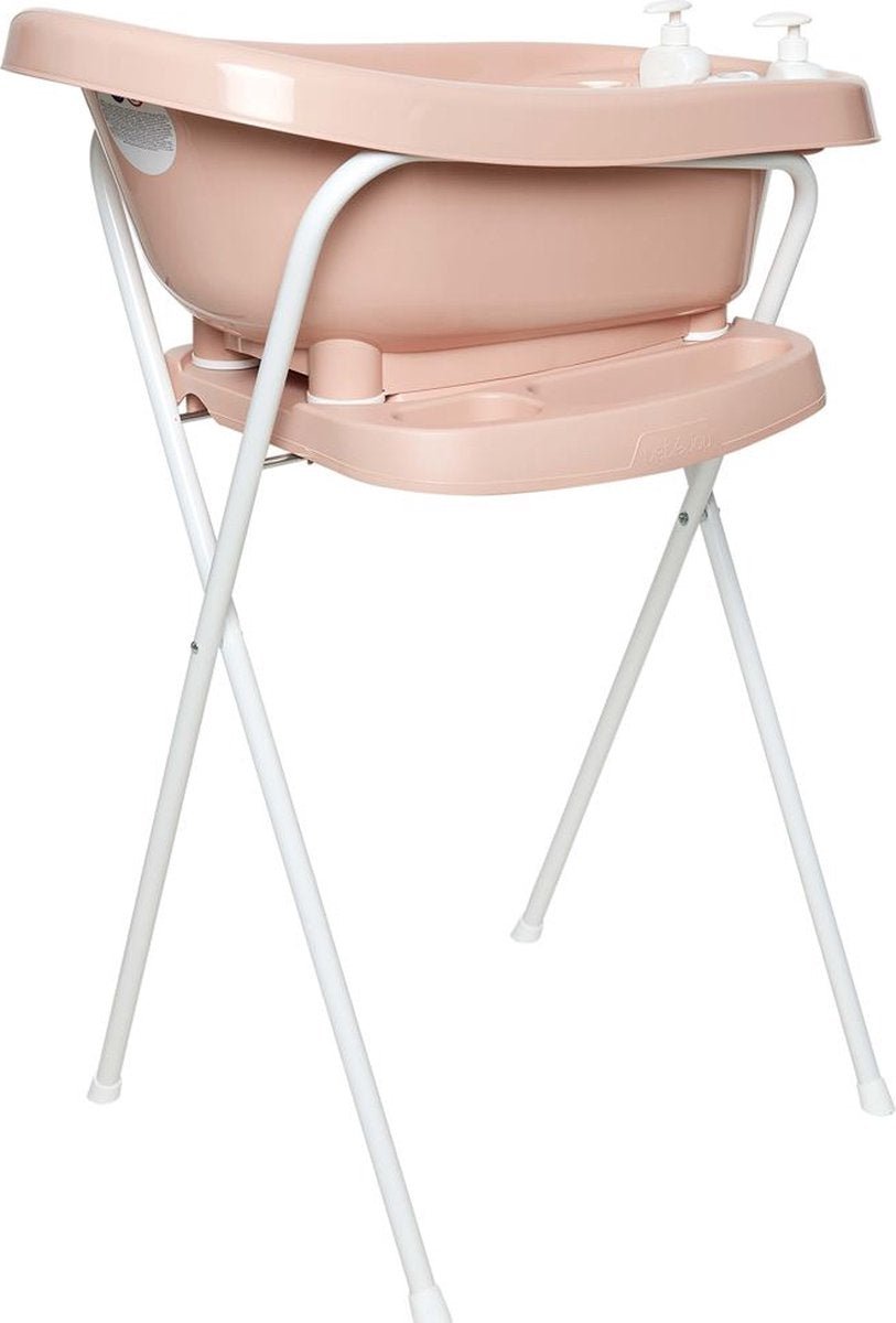 Pale pink baby bath tub on white metal stand with handles