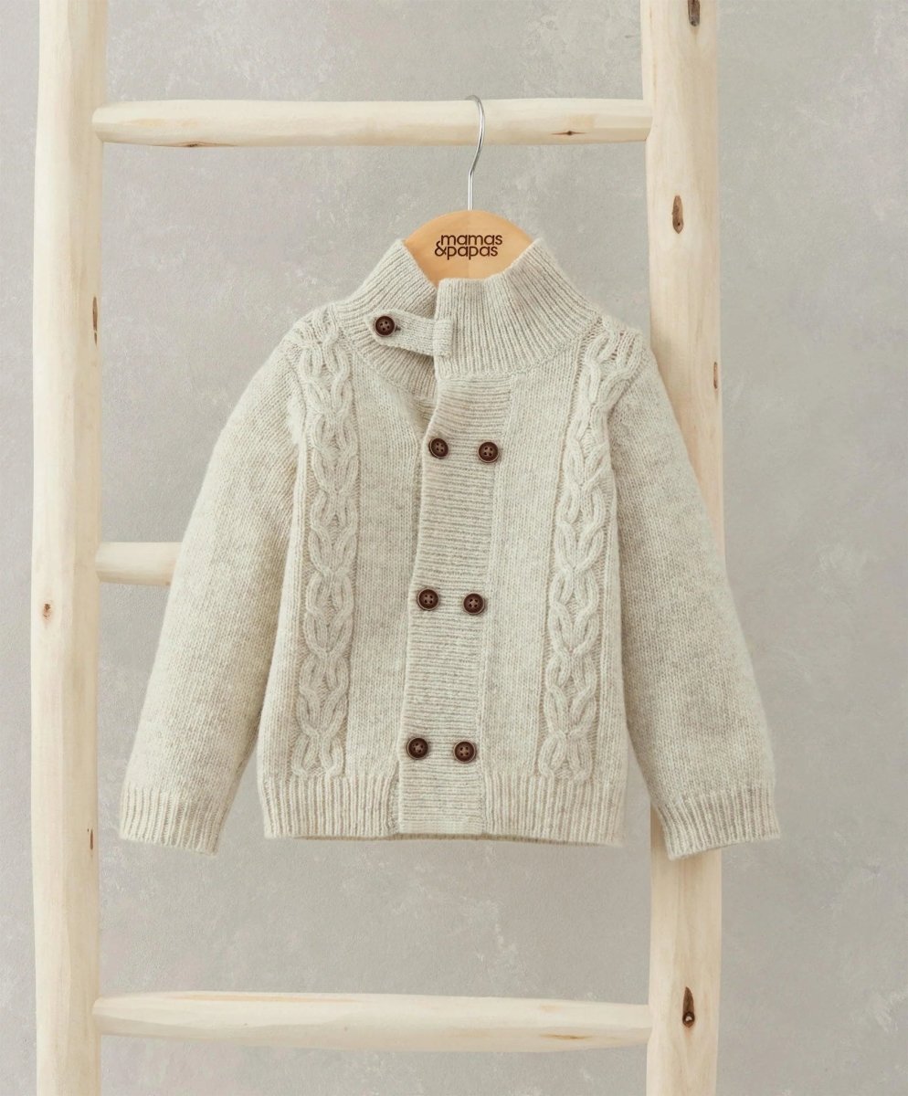 Cream cable knit cardigan with stand collar, double-breasted buttons and textured knit