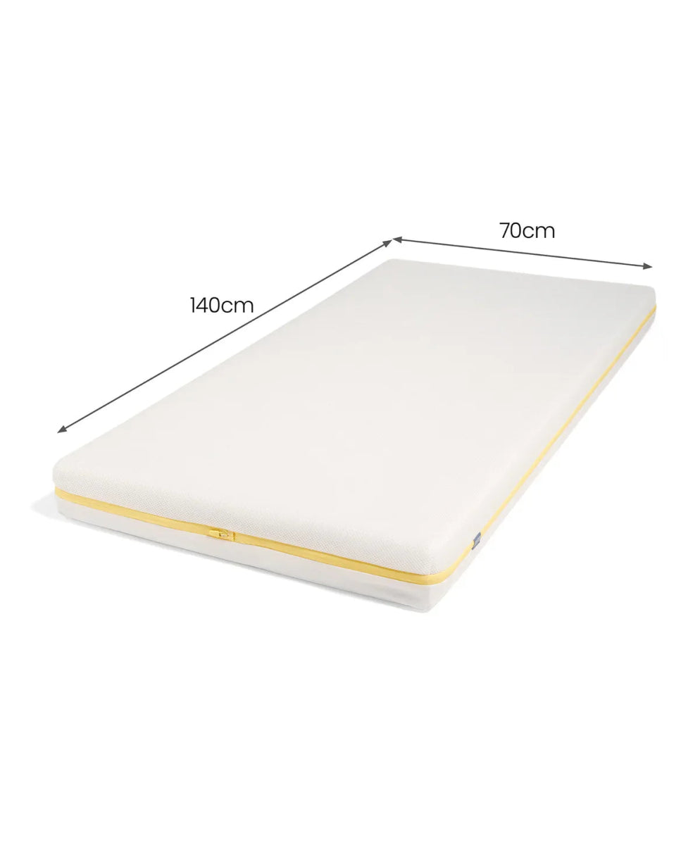 Cotbed mattress with white cover and yellow edge piping, size 140cm by 70cm