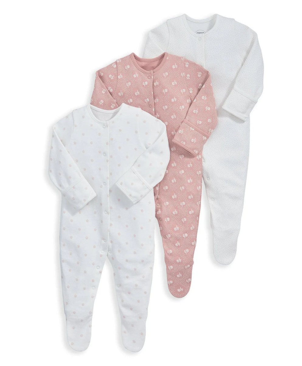Three long-sleeve footed sleepsuits: blush floral, light floral, and solid white