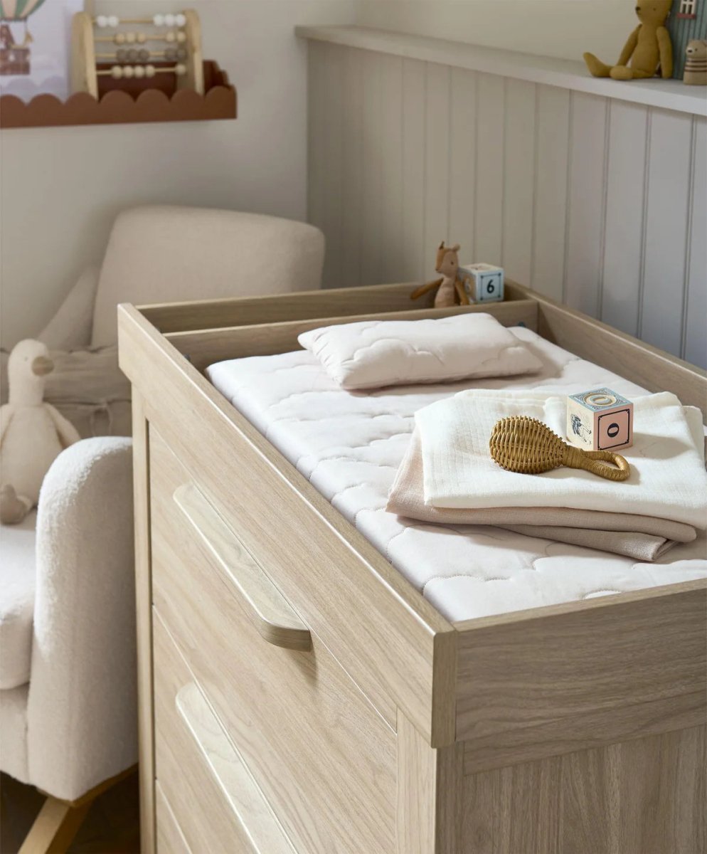 Oak dresser changer with changing pad on top and two drawers front