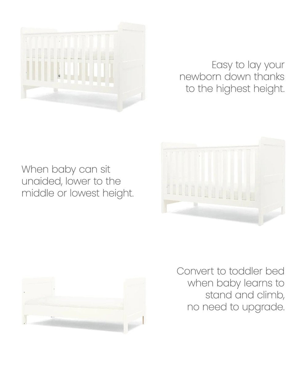 White cotbed with adjustable rail heights, side view showing end panels and slats