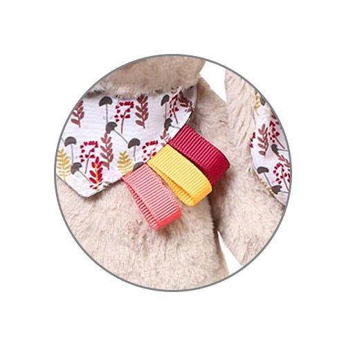 Close-up of plush rabbit keychain fabric ribbons in red, yellow, and striped print