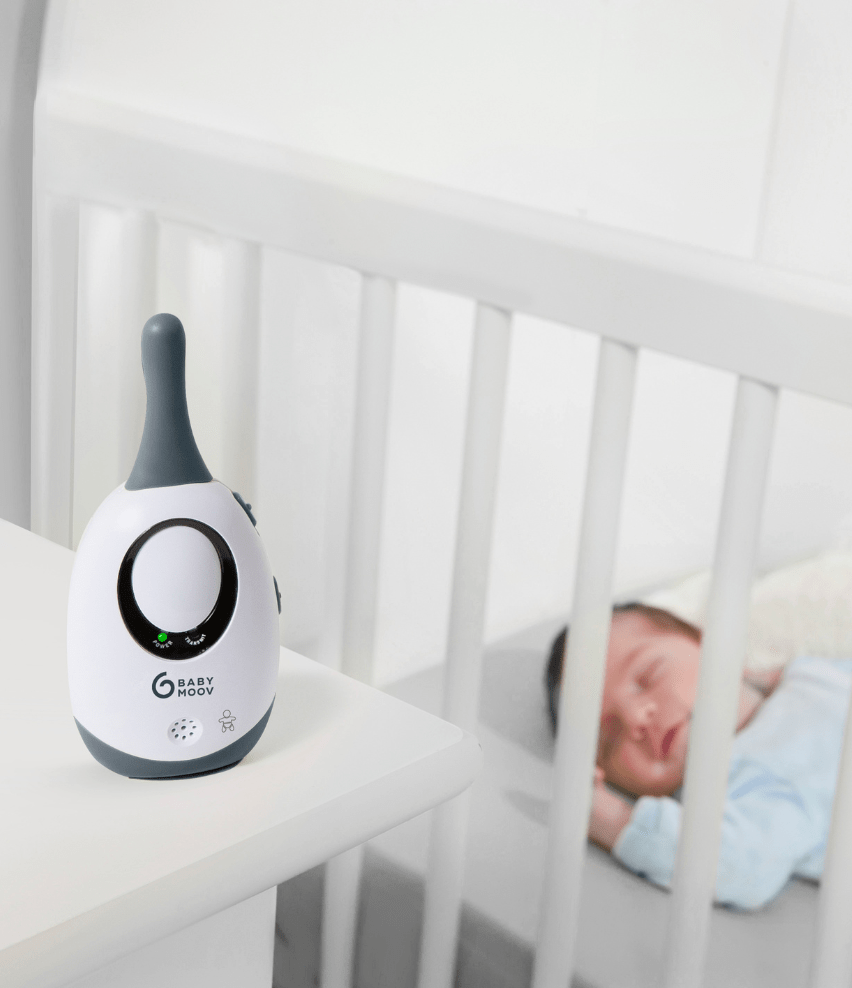 Baby monitor adapter on tabletop, white body with dark top and oval display