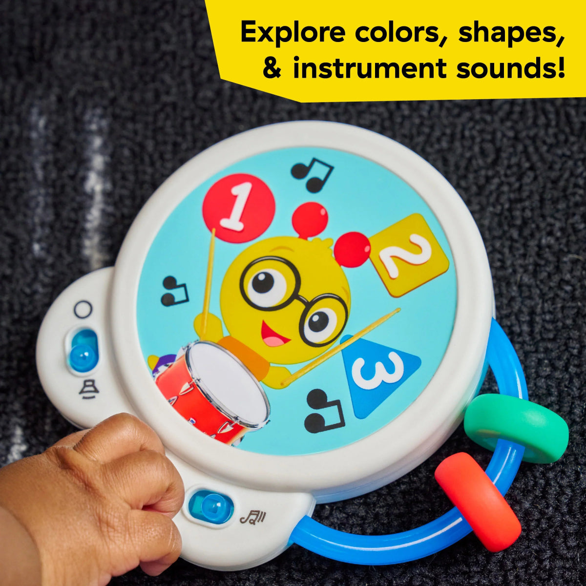 Musical toy panel close-up with numbers, drum, and colored buttons
