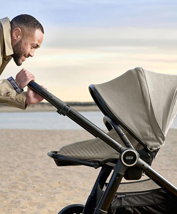 Ocarro stroller with gray canopy, black frame, and reclining seat, side view