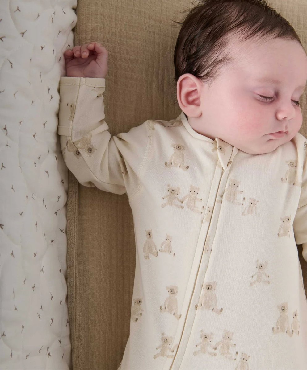 Cream teddy-print all-in-one romper with zip front and snap details at cuffs