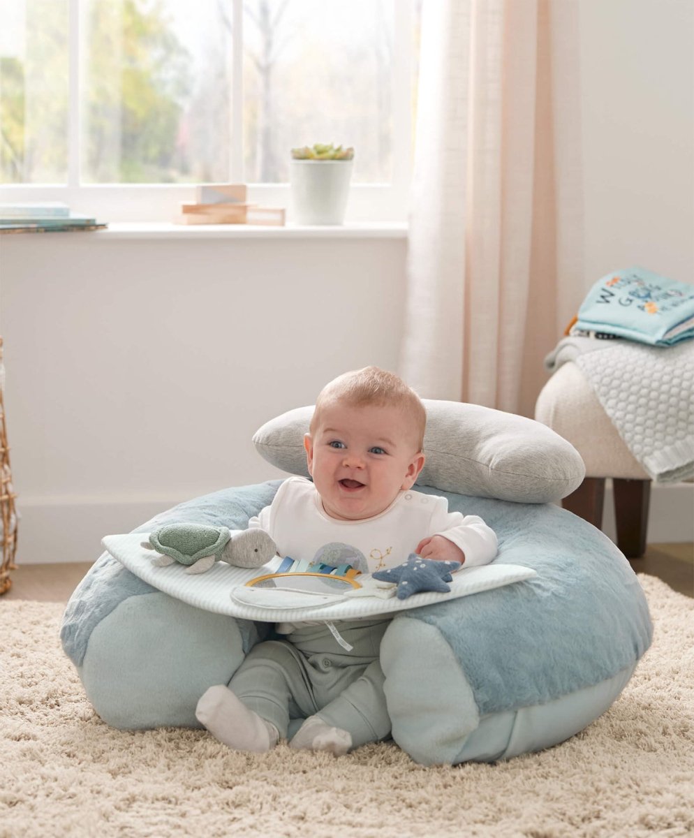 Blue undersea interactive seat with activity panel, baby smiling