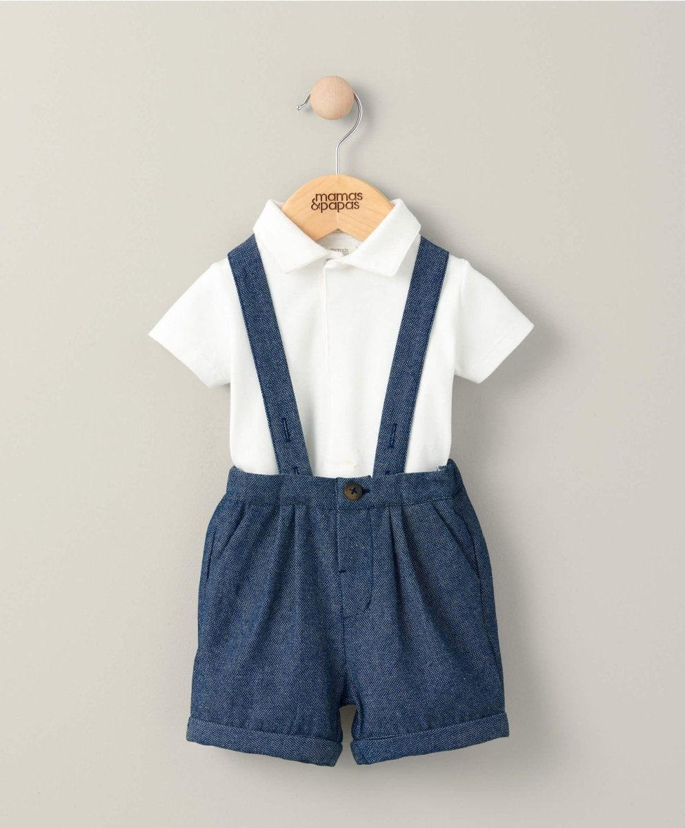 Blue woven dungarees shorts with white collared bodysuit and adjustable straps