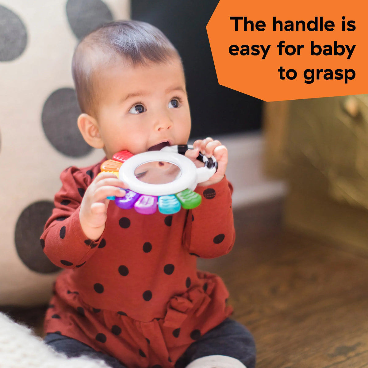 Octopus rattle and teether toy in baby hands, easy-grip handle with colorful parts
