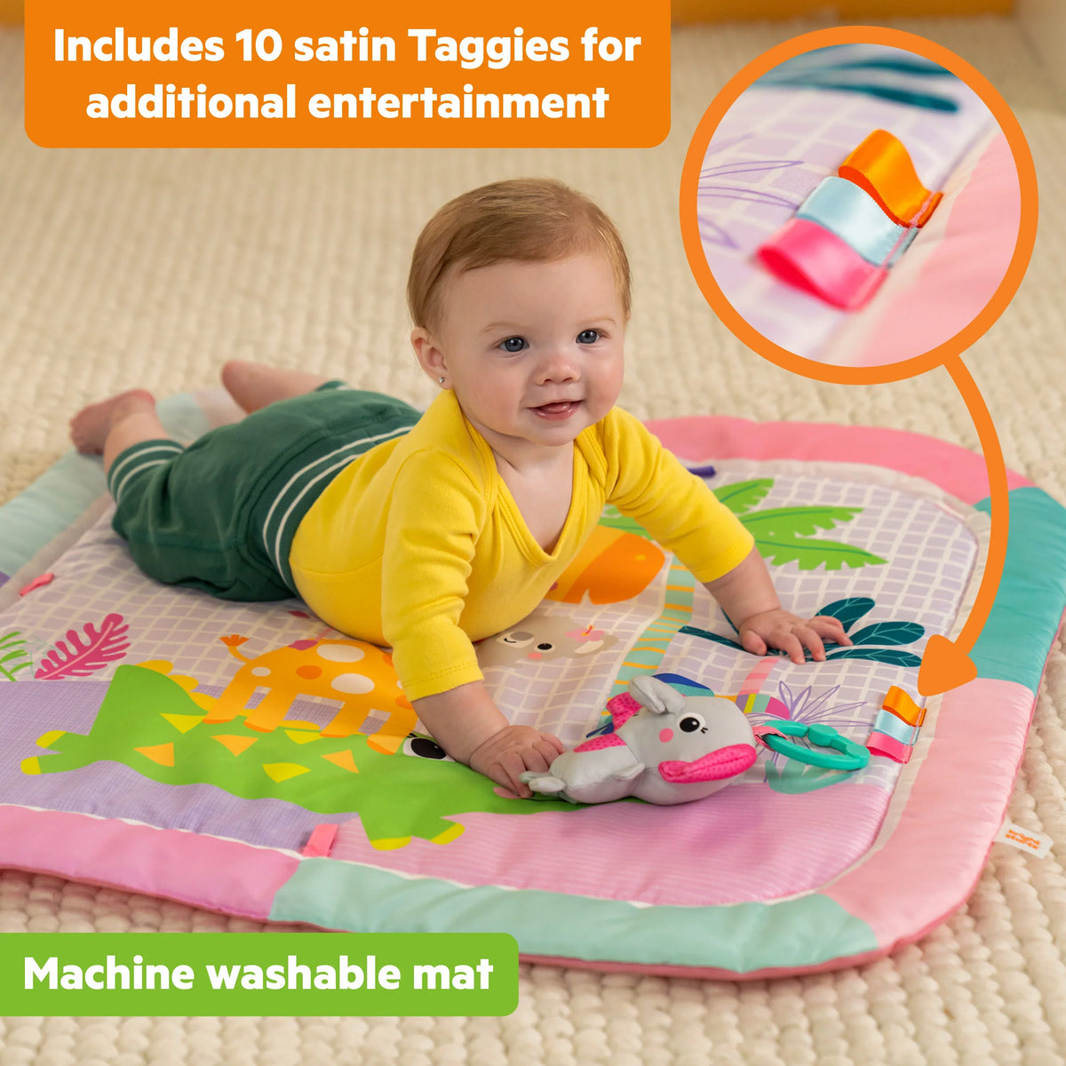 Baby playing on pastel activity gym mat with arch toys and plush animal