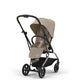 Almond beige stroller with canopy, reclining seat, and four-wheel frame