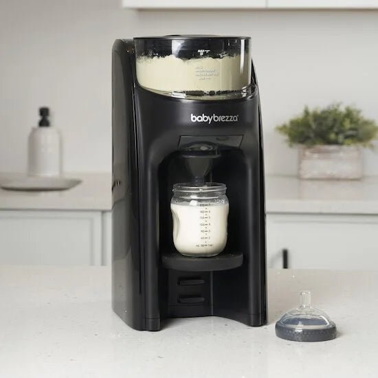 Black babybrezza Formula Pro Advanced formula maker with bottle in dispensing chamber