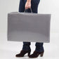 Grey folding mattress with carrying handles, compact rectangular pack
