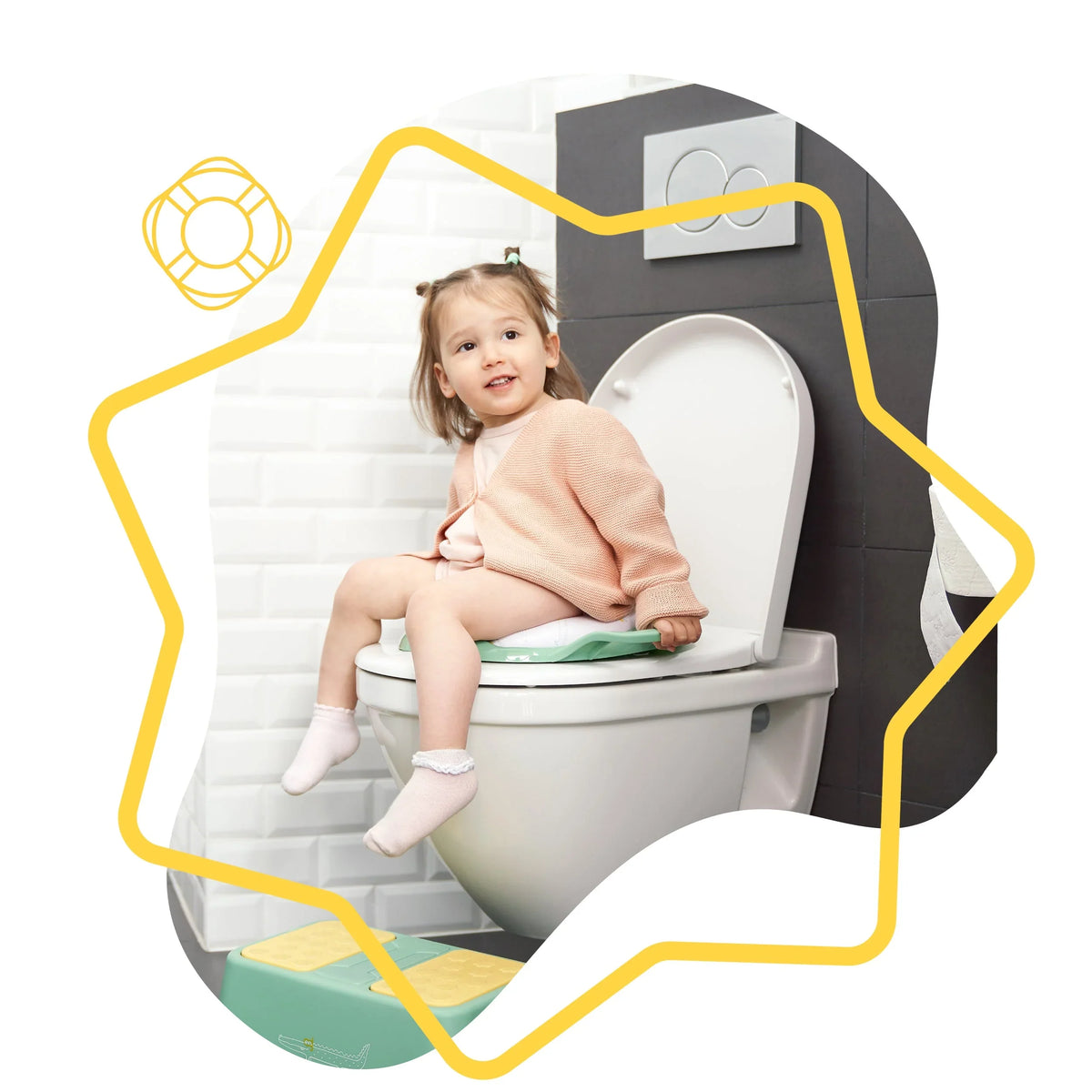 Comfort toilet reducer with handles, green, shown on toilet with child sitting