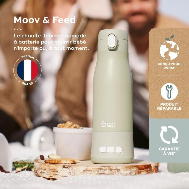 Sage green baby bottle warmer with button and carry handle, standing on table