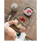 Baby weaning tray set with plates and cup on wooden table, includes spoon