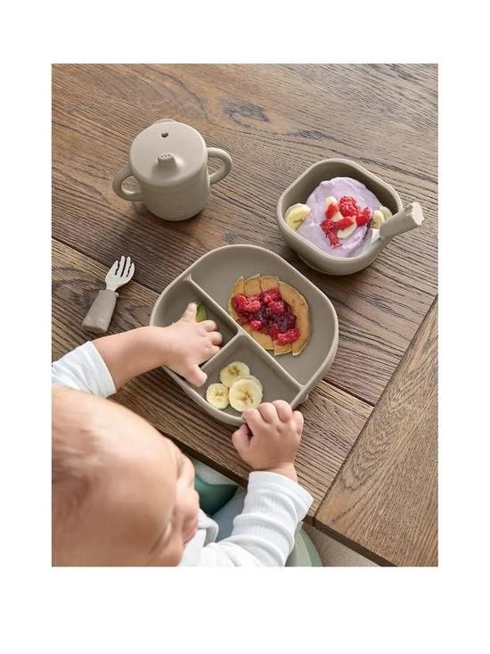 Baby weaning tray set with plates and cup on wooden table, includes spoon