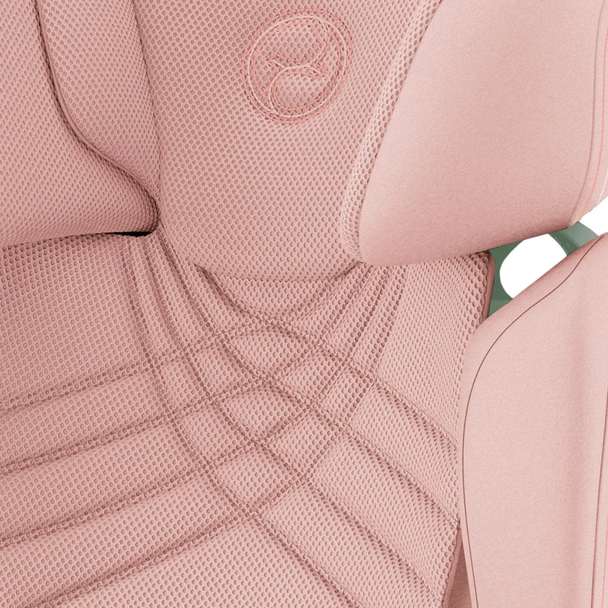 Peach pink child car seat upholstery close-up with textured fabric and stitched lines