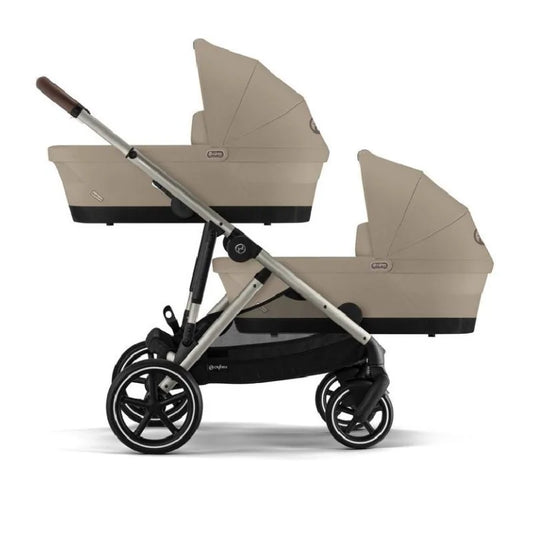 Stroller carrycot attachment in beige with dark base, mounted on a pushchair frame
