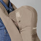 Beige baby carrier close-up of shoulder panel, tag patch, and fastening