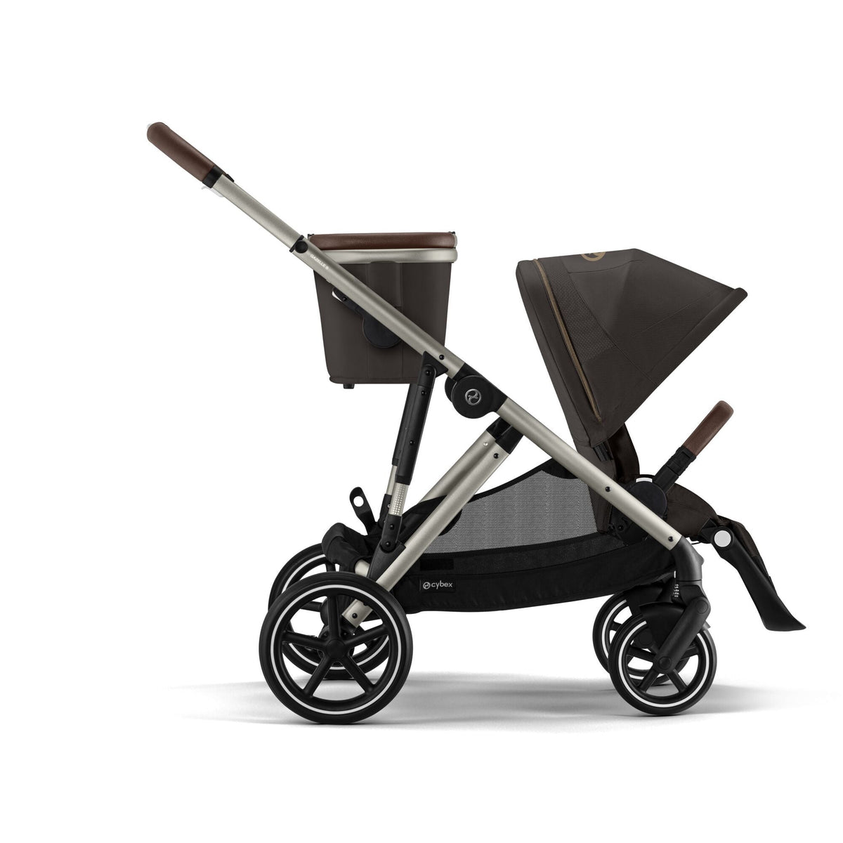 Baby stroller side view with dark seat and canopy, chocolate-brown handlebar, silver frame, wheels