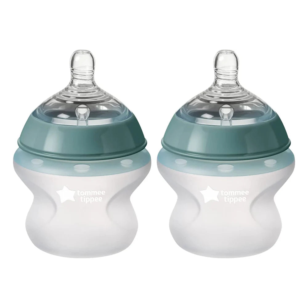 Two silicone baby bottles, teal top and white body with clear nipples