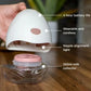 Wearable cordless breast pump with 150 ml milk collector jar, shown in hand