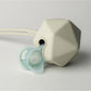 Silicone teether and pacifier set in light green, octagonal teether with soother