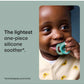 Baby holding a teal night-glow one-piece silicone pacifier