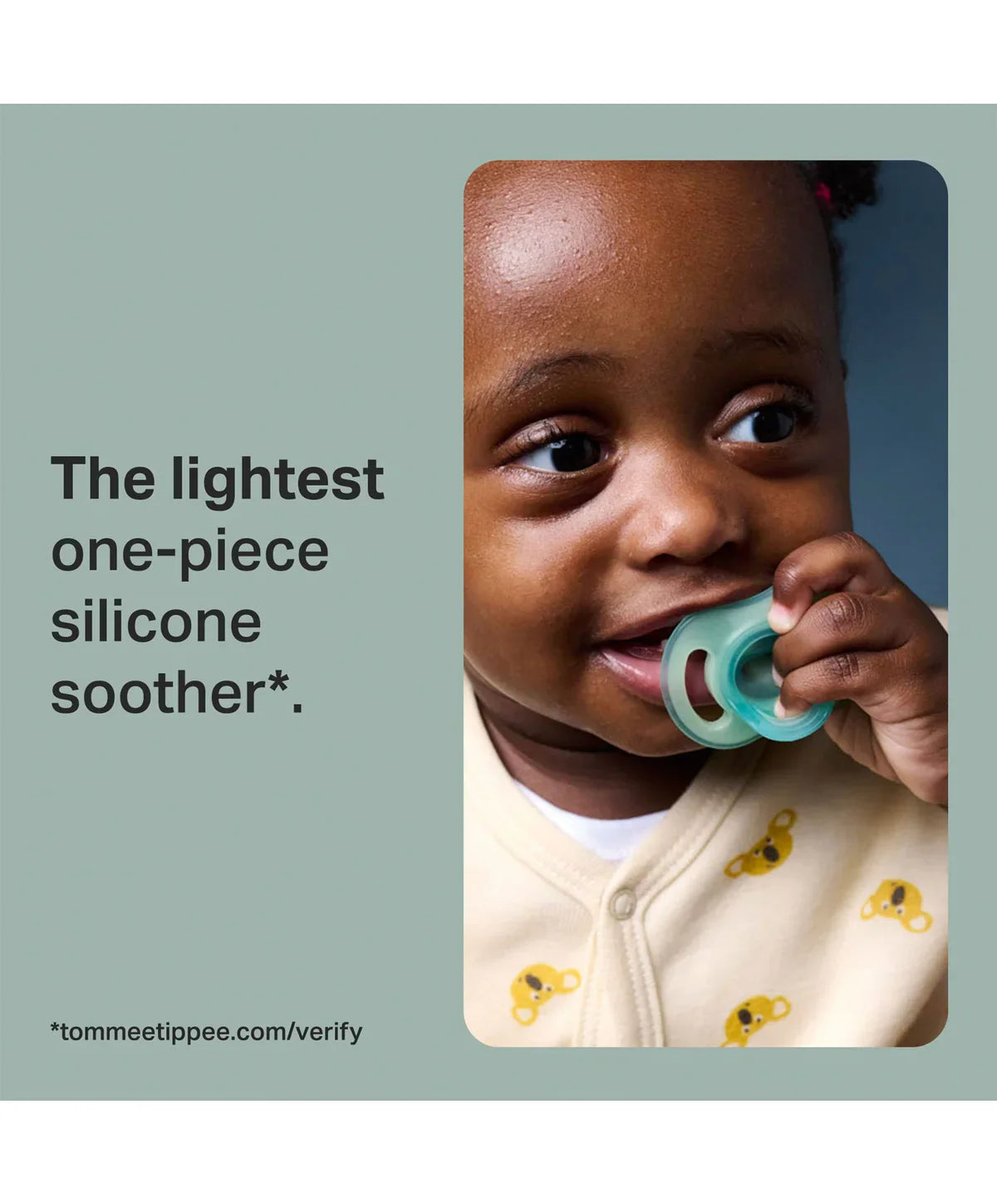 Baby holding a teal night-glow one-piece silicone pacifier