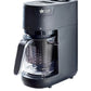 Black baby food maker with blending jug and lid on countertop