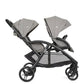 Double stroller with two gray seat covers, black wheels and frame, angled view