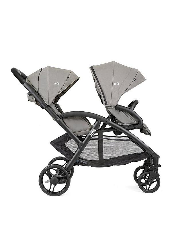 Double stroller with two gray seat covers, black wheels and frame, angled view