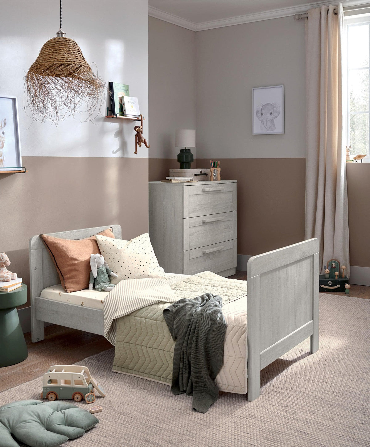Nimbus White cotbed with slatted sides and open end, shown from the side.