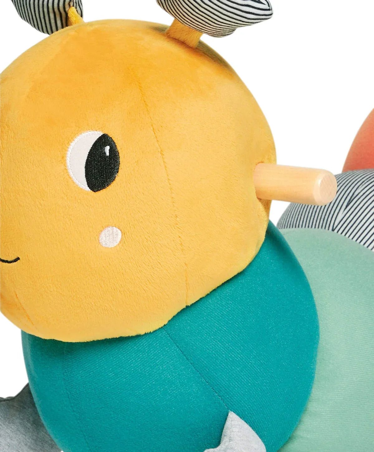Stuffed caterpillar rocking toy close-up of yellow face and teal body