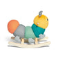 Stuffed rocking caterpillar toy with yellow head, teal body, orange rear, wooden rockers