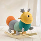 Stuffed rocking caterpillar toy with yellow face, teal body, striped ears and legs