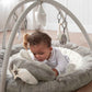 Elephant playmat gym with arch and dangling plush toys, child playing on gray cushion