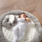 Elephant playmat gym with gray cushioned mat and plush elephant beside baby on it