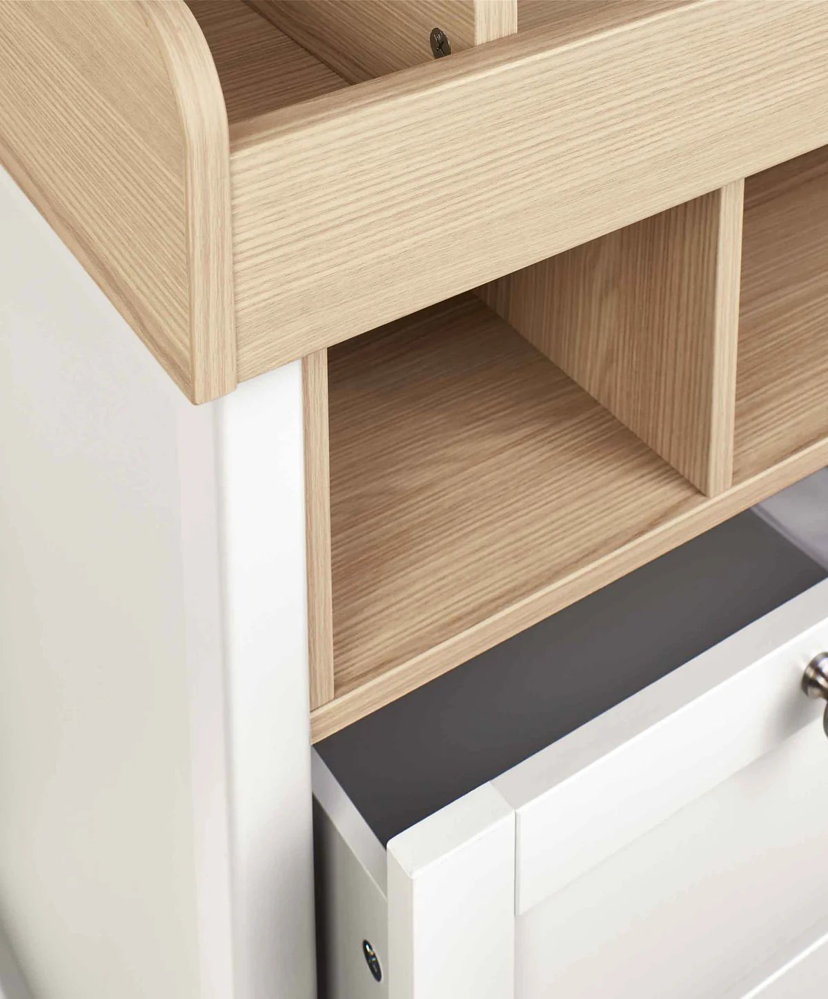 White dresser changer with light wood shelving and lower drawer with round knob