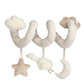 Spiral activity toy with plush star, moon, and duck charms on off-white arms