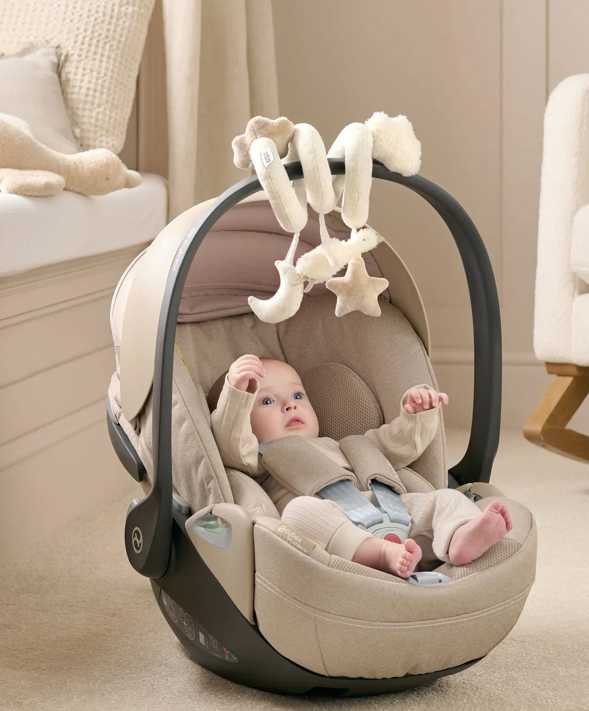 Spiral activity toy mounted on baby seat, with hanging star and duck plush